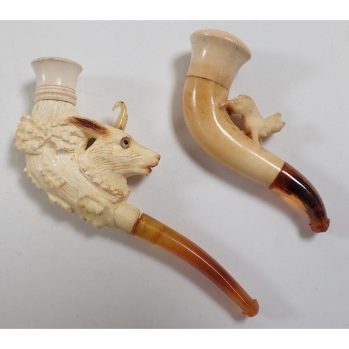 963 - Two amber and meerschaum cheroot holders, one a carved goat with glass horns and eyes, one with smal... 