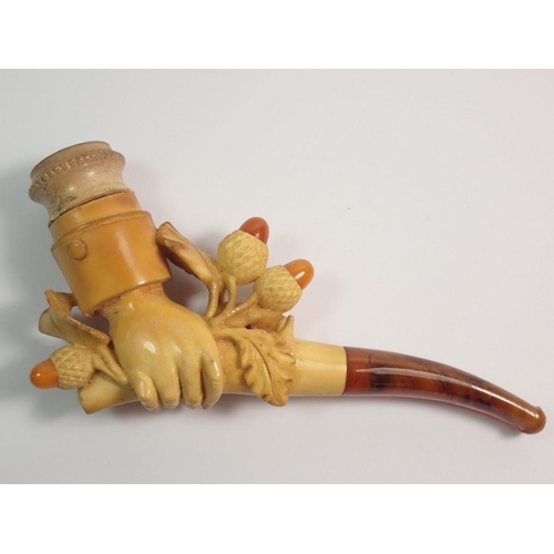 966 - An amber and meerschaum cheroot holder carved as a hand holding a branch of acorns - cased