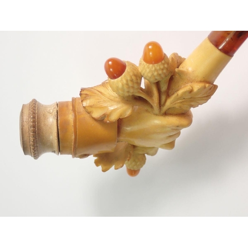 966 - An amber and meerschaum cheroot holder carved as a hand holding a branch of acorns - cased