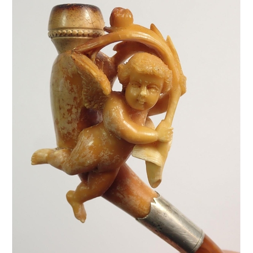 967 - An amber and meerschaum cheroot holder with carved cherub holding spray of foliage - cased