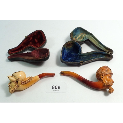 969 - Two amber and meerschaum cheroot holders, one with bearded man in animal head helmet, one in the for... 