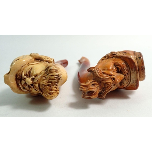 969 - Two amber and meerschaum cheroot holders, one with bearded man in animal head helmet, one in the for... 