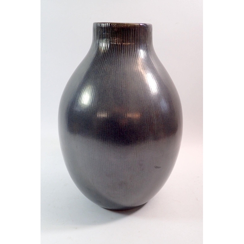 97 - A black ribbed large studio pottery vase, impressed marked Barlane, 34cm