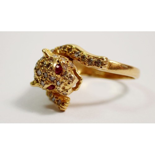 432 - An 18 carat gold diamond set ring in the form of a leopard, with ruby eyes, size K, 5.5g