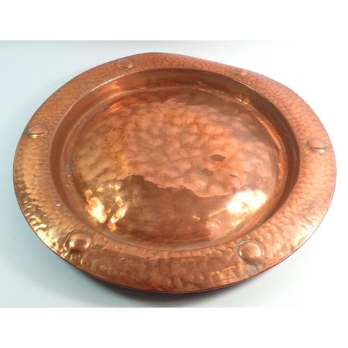 1090 - A set of three copper embossed circular dishes, largest 43cm