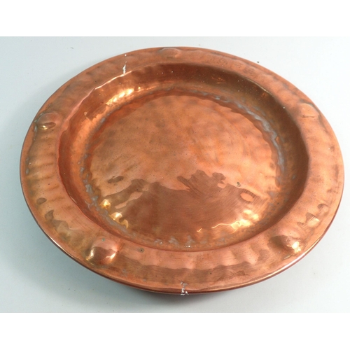 1090 - A set of three copper embossed circular dishes, largest 43cm