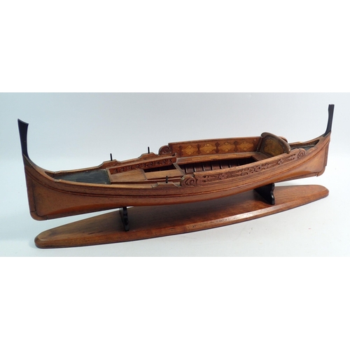 1106 - An early 20th century wooden model of a Maltese Dghajsa boat, 47cm long