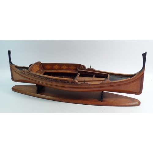 1106 - An early 20th century wooden model of a Maltese Dghajsa boat, 47cm long