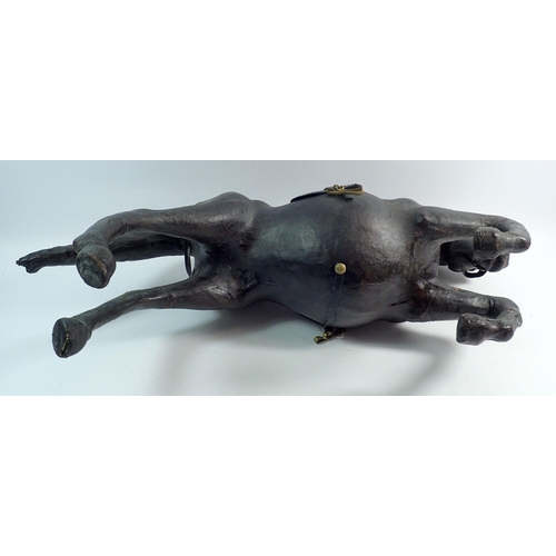 1113 - An early 20th century large leather covered bowing horse, 62cm long