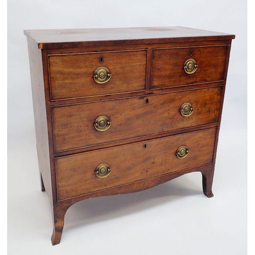 1113A - An early 19th century small mahogany chest of two short and three long drawers with circular brass h... 