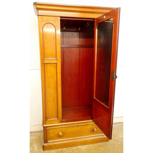 1120 - A Victorian mahogany single door wardrobe with arch panels over drawer