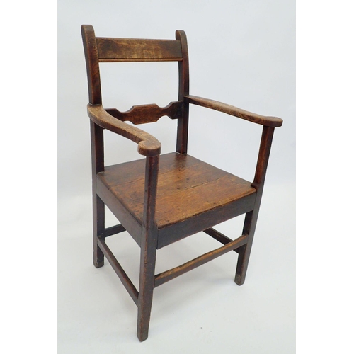 1133 - A Georgian oak chair with solid seat