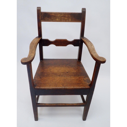 1133 - A Georgian oak chair with solid seat