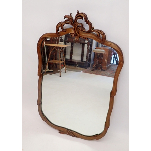 1137 - A vintage gold mirror with foliage decoration and ribbon/scroll design surround, 105cm high