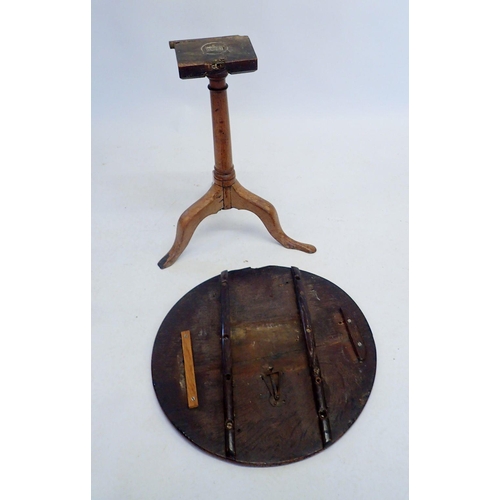 1145 - A Georgian oak tilt top occasional table on turned column and triple scroll supports (supports worn)... 