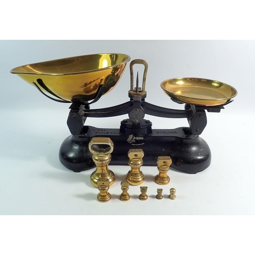 1148 - A pair of kitchen cast iron and brass scales and weights