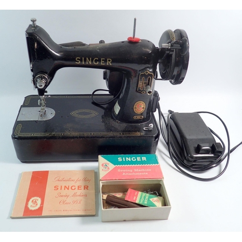 1173 - A Singer 99K sewing machine with instruction manual and foot control pedal together with a Child's G... 