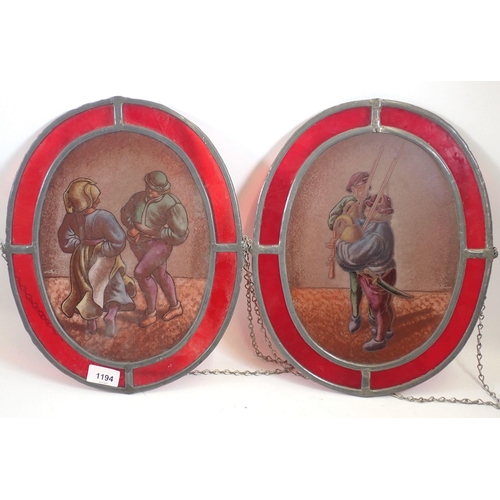 1194 - Two stained glass oval panels depicting couple country dancing and two bagpipers, 35 x 28cm