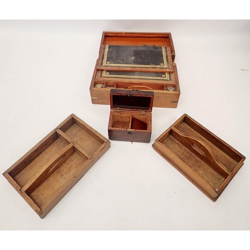 1207 - A 19th century mahogany rectangular tea caddy and two stained wood cutlery trays and a writing slope... 