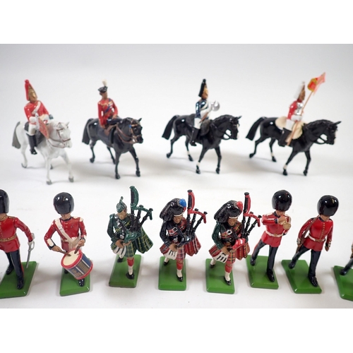 1219 - A group of 18 Britains lead painted figures including Elizabeth II riding side saddle, soldiers, pol... 