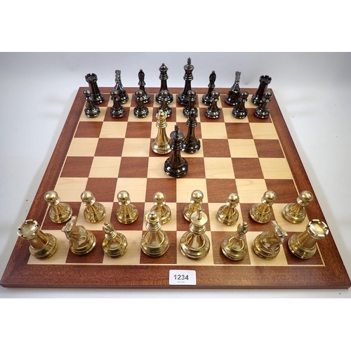 1234 - A Spanish turned brass and bronze finish chess set and marquetry chess board, 50 x 50cm