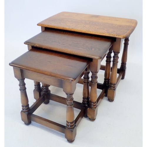 1316 - A nest of oak occasional tables on turned supports, largest 59 x 37cm