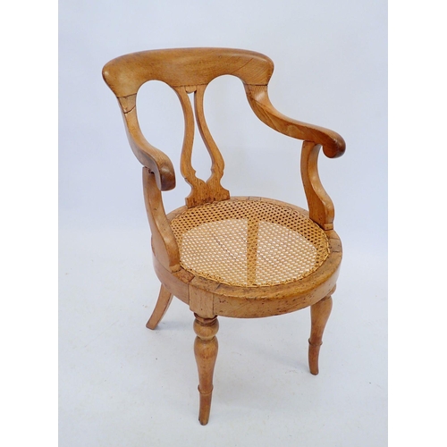 1324 - A late Victorian oak and cane Captain's chair with vase splat