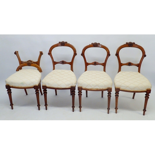 1331 - A set of four Victorian walnut dining chairs with carved backs and fluted tapered supports