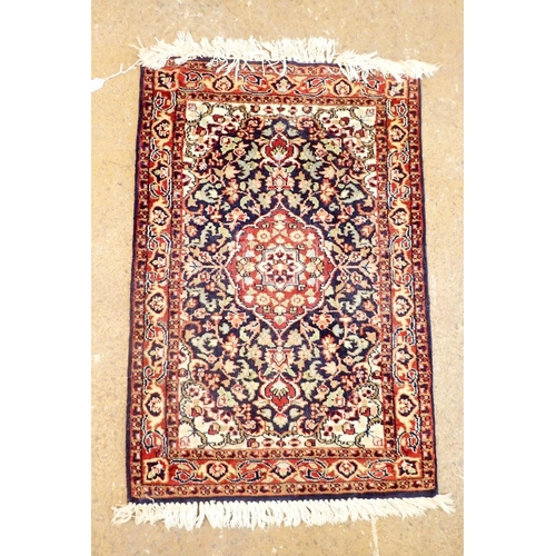 1360 - A small Persian rug with medallion design on blue floral ground 93 x 62cm