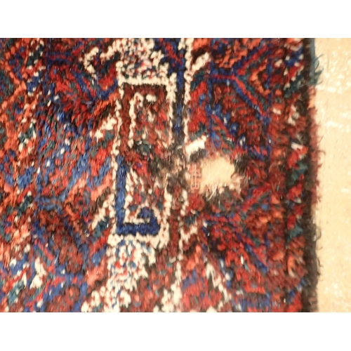 1361 - A Turkoman rug with triple lozenge design on a red ground 326 x 228cm