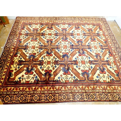 1365 - A Turkmanistan Persian large carpet with geometric and stylised floral decoration on a cream ground ... 