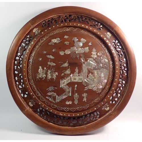 1378 - A Chinese carved wood circular plaque with mother of pearl inlaid decoration of palace scene and att... 