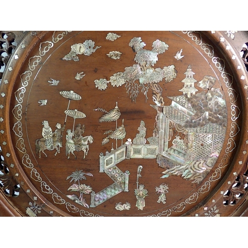 1378 - A Chinese carved wood circular plaque with mother of pearl inlaid decoration of palace scene and att... 