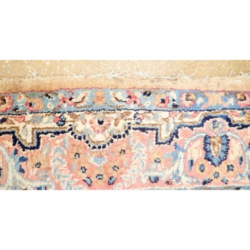 1384 - A Persian style rug with stylised floral design on a pale pink ground 201 x 148cm