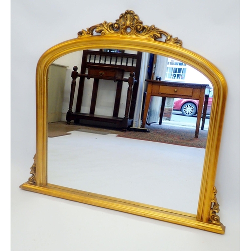 1416 - A Victorian style gilt overmantel mirror with floral surmount 112cm wide 99cm tall