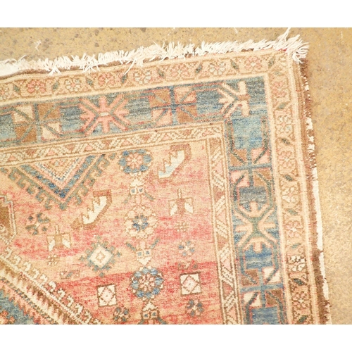 1422 - A Turkoman style rug with blue geometric design on a pink ground 201 x 134cm