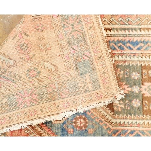 1422 - A Turkoman style rug with blue geometric design on a pink ground 201 x 134cm