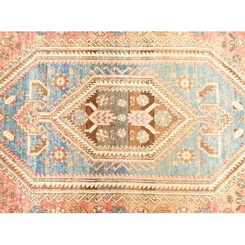 1422 - A Turkoman style rug with blue geometric design on a pink ground 201 x 134cm