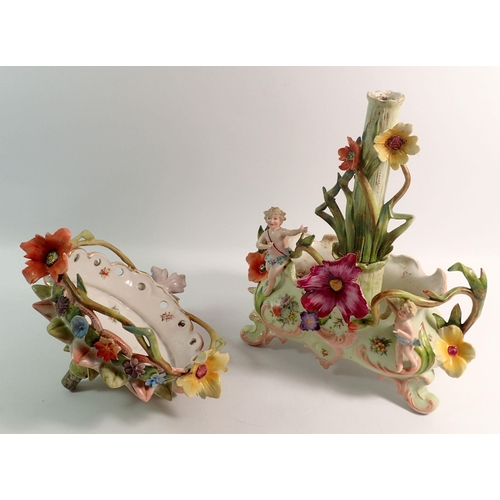 154 - An early 20th century continental centrepiece comport with floral encrusted bowl and stem on oval ba... 