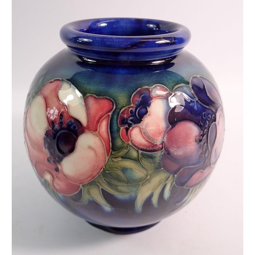 192 - A Moorcroft spherical vase painted anemones on a blue ground, by William Moorcroft with paper label,... 