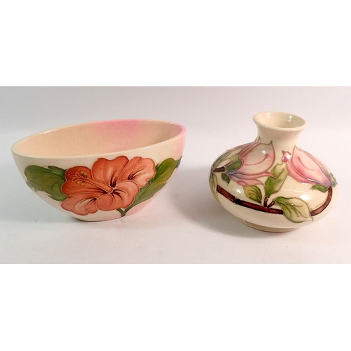 193 - A Moorcroft Magnolia vase on a cream ground, 11cm and a hibiscus oval vase on a cream ground