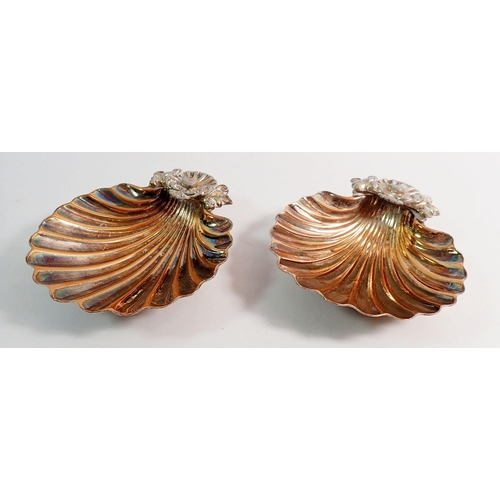 242 - A pair of silver plated shell form butter dishes, 13cm diameter