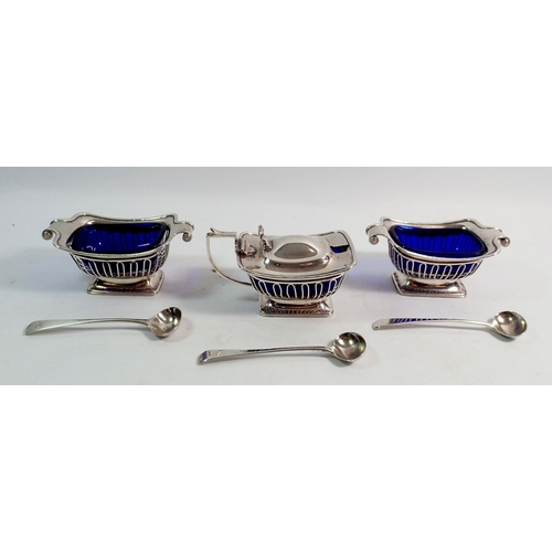 289 - A rectangular pierced silver three piece cruet set with blue glass liners and three matched spoons, ... 