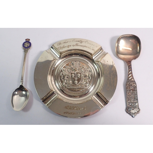 315 - A silver presentation ashtray, a silver spoon, 150g and a silver plated spoon