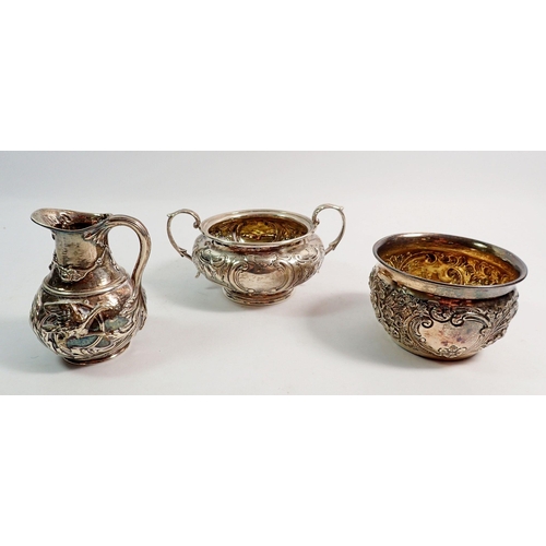 316 - Two silver sugar bowls and a silver jug - all with embossed decoration, 289.5g