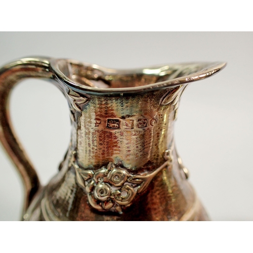 316 - Two silver sugar bowls and a silver jug - all with embossed decoration, 289.5g