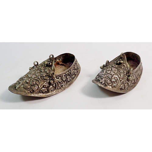 321 - A pair of Indonesian white metal children's shoes with embossed decoration, 11cm long