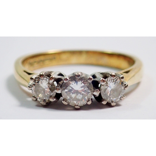 363 - An 18 carat gold three stone diamond ring, size L, 3.8g