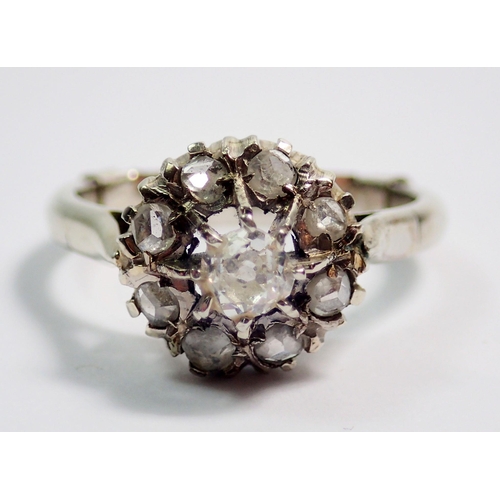 365 - An antique diamond cluster ring set old cut diamonds on later white gold band