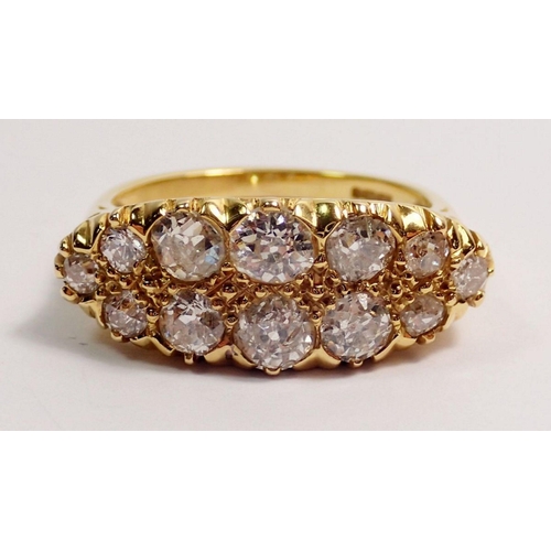 366 - An 18 carat gold ring set double row of twelve graduated diamonds, largest stones 4mm, size N, 5.3g